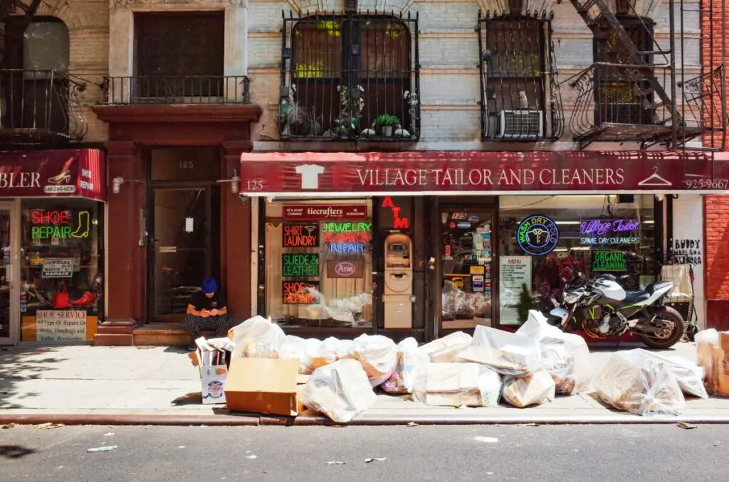 Big pile of garbage in front of apartment building.